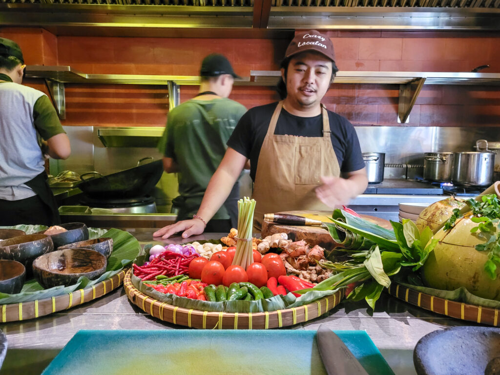 Chef Putu of Nusantara restaurant in Bali shows ingredients used in flavorful condiments including Bumbu Bali and Sambal. (Heather Irwin/The Press Democrat)