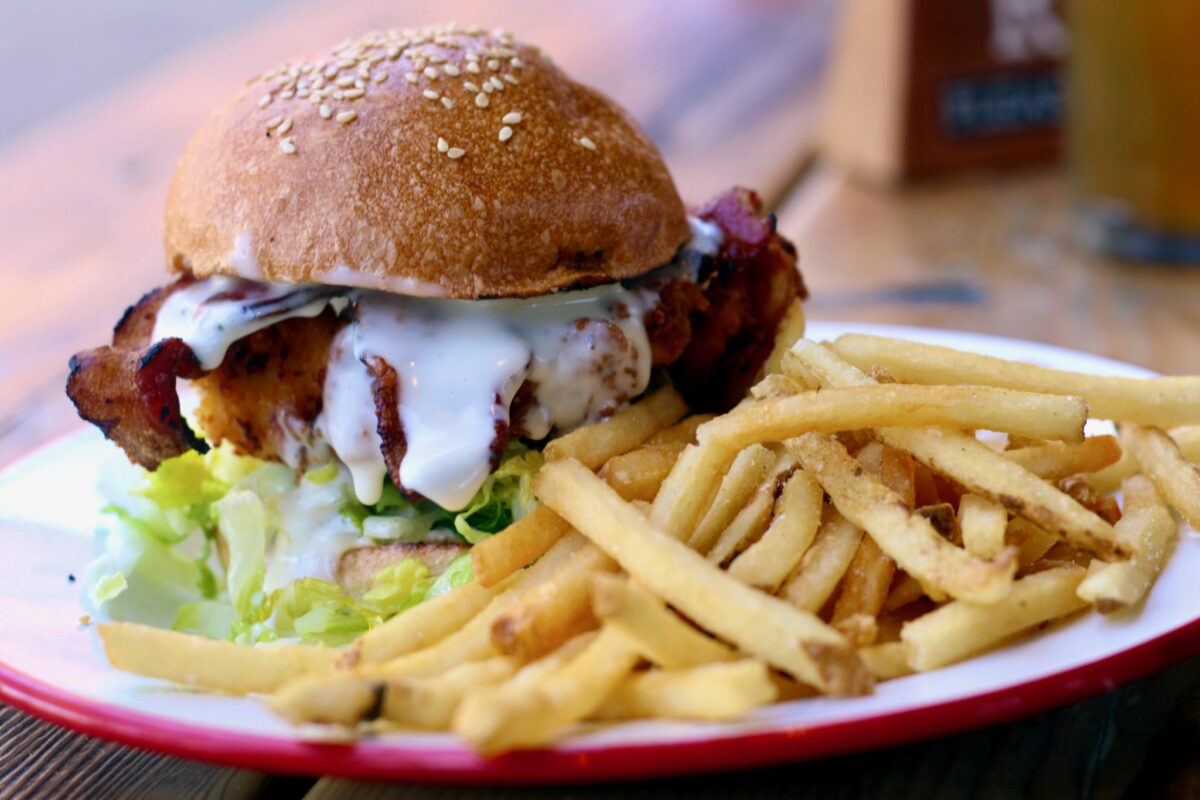 Fried chicken sandwich with goat cheddar, romaine, garlic mayo, bacon, Della Fattoria bun and a side of fries at Brewsters Beer Garden in Petaluma. (Heather Irwin/The Press Democrat)