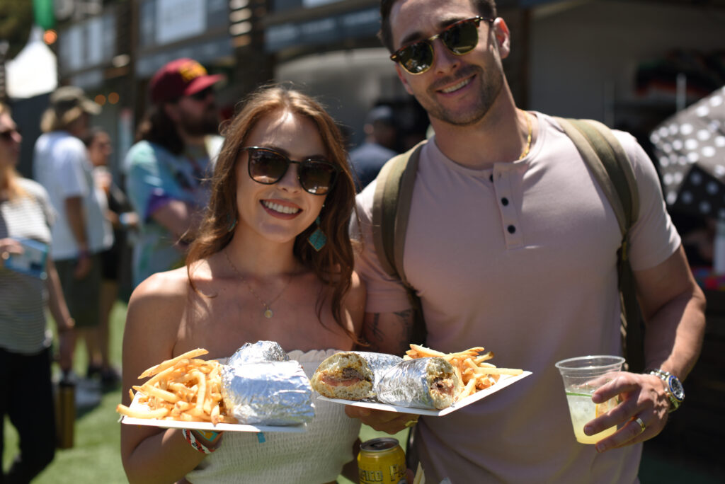 Bethany and Tao Sabella of Brentwood with their filet mignon sandwiches from Ristorante Allegria on Friday, May 27, 2022, during BottleRock Napa Valley in Napa. (Erik Castro / For The Press Democrat)