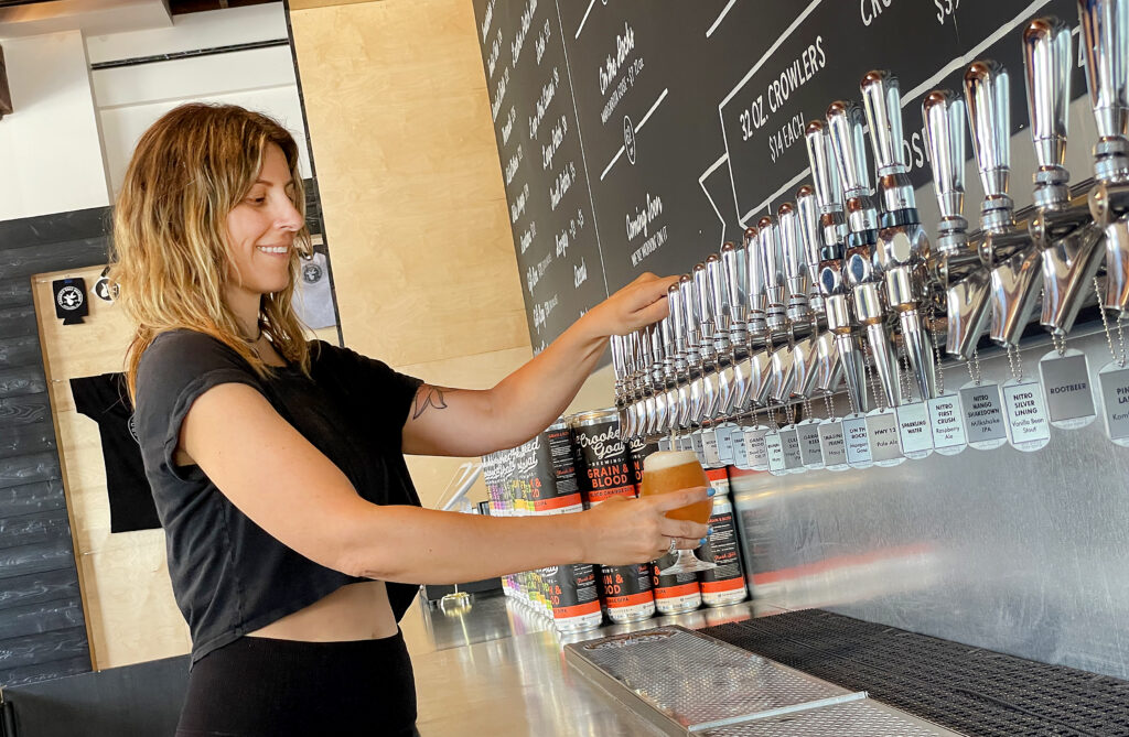 Karly Church serves up a beer at the new Crooked Goat Brewing Co. taproom on Howard St. in Petaluma on May 17, 2022. (John Burgess/The Press Democrat)