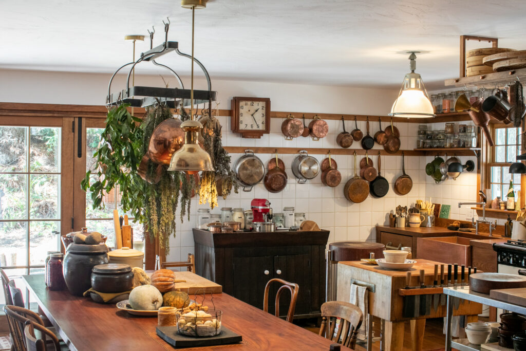 The old cottage kitchen was completely reimagined as the center of the home, with hand-built wooden counters and peg rails, and a deep copper sink. (Eileen Roche)