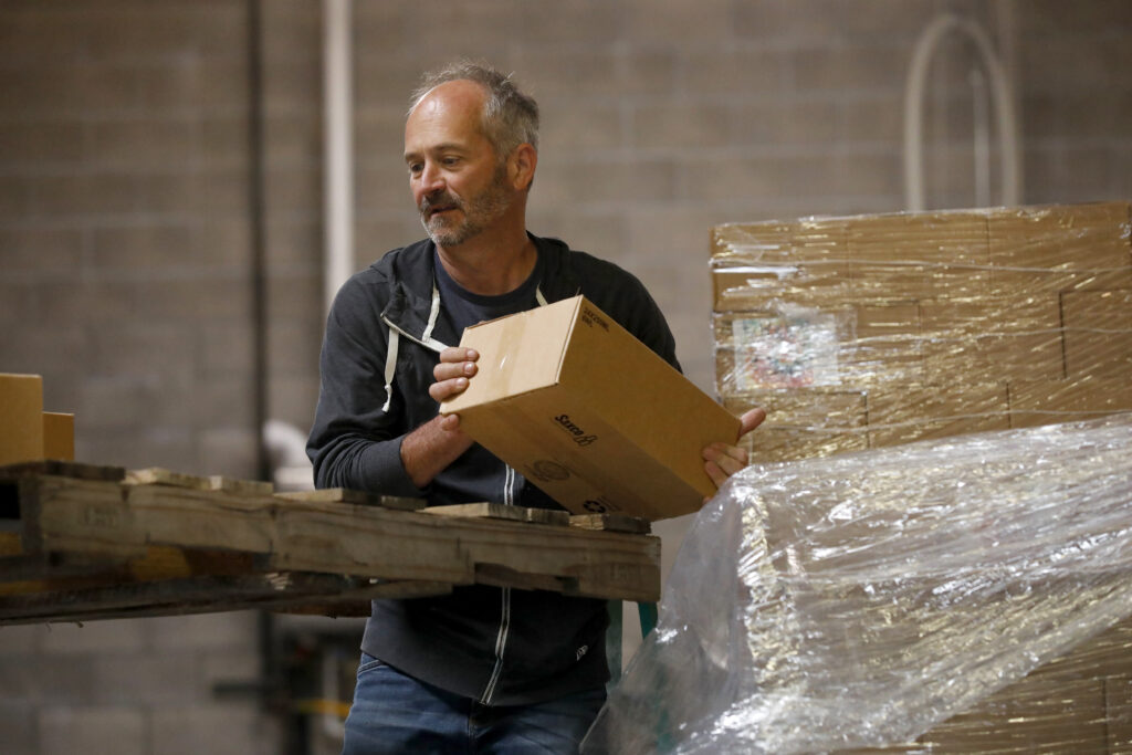 Winemaker William Allen loads boxes of canned wine for a distributor at Two Shepherds in Windsor, Calif. on Tuesday, May 31, 2022. (Beth Schlanker/The Press Democrat)