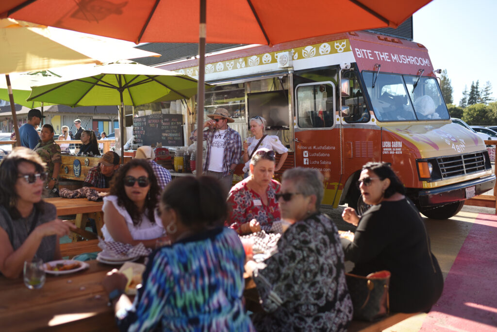 Attendees dining from the many trucks during the ribbon cutting celebration of the new Mitote Food Park on Sebastopol Road in the Roseland neighborhood of Santa Rosa, Calif. on Thursday, July 14, 2022. (Erik Castro / For The Press Democrat)