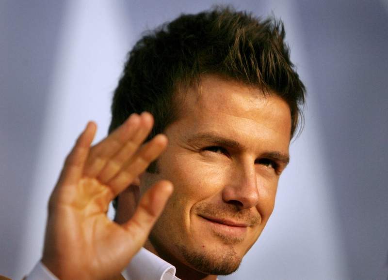 ** FILE ** Real Madrid soccer star David Beckham waves to fans during a promotional event in Tokyo in this Friday, Dec. 29, 2006 file photo. (AP Photo/David Guttenfelder)