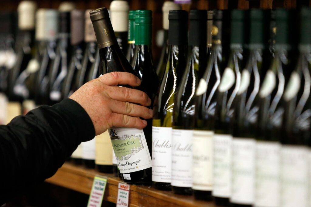 Vineyard manager Danny Smith browses the display of French wines at Bottle Barn in Santa Rosa, California. (Alvin Jornada / The Press Democrat)