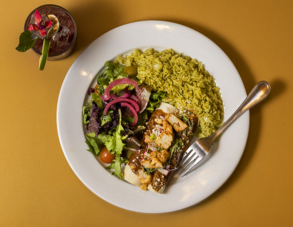 Chicken Enmoladas with cilantro rice and baby greens salad from Kina's Kitchen & Bar in Sonoma. (John Burgess/The Press Democrat)