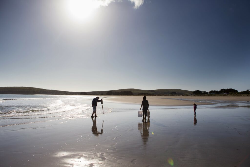Gerard Nebesky searches Doran Beach with his partner, Anna Ming, and their 3-year-old daughter, Olive, for signs of clams by tapping the sand with his shovel. The seafood that he finds and traps in the shallow waters at Doran Beach will be used in his paella, which he calls a social dish. Shot on Monday, March 2, 2015 at Doran Beach in Bodega Bay, Calif. (Charlie Gesell/ For Sonoma magazine)