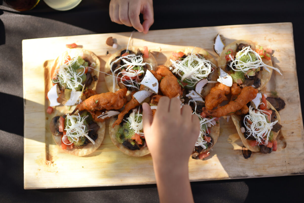 Young children enjoying tacos de hongos (mushroom tacos) from the Lucha Sabina truck during the ribbon cutting celebration of the new Mitote Food Park on Sebastopol Road in the Roseland neighborhood of Santa Rosa, on Thursday, July 14, 2022. (Erik Castro / For The Press Democrat)