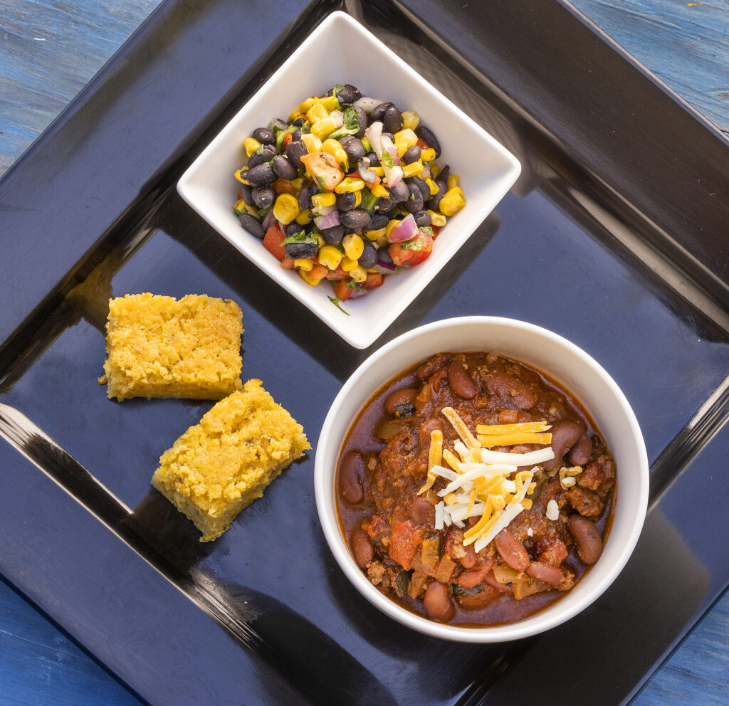 Beef and Bean Chili with Corn & Black Bean Salad and a side of The Best EverChile Cheese Cornbread from A La Heart Kitchen in Forestville Friday, July 1, 2022. (John Burgess / The Press Democrat)