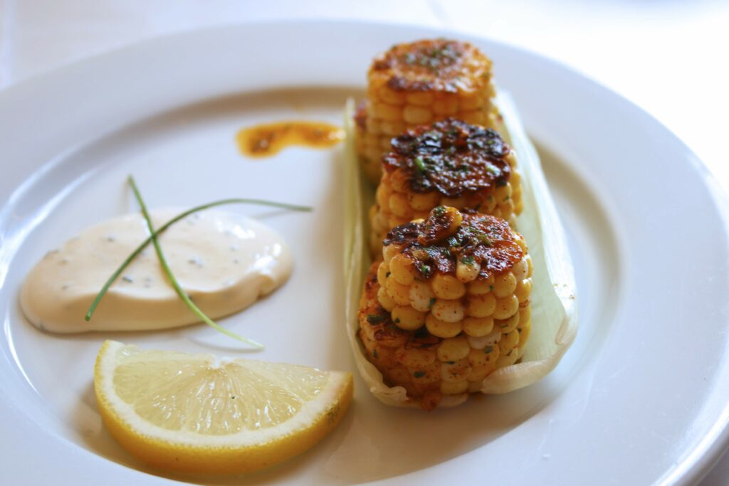Elotitos, or oven-roasted corn, with Jamaican jerk seasoning and chive crema at Guiso Latin Fusion. (Heather Irwin/Sonoma Magazine)
