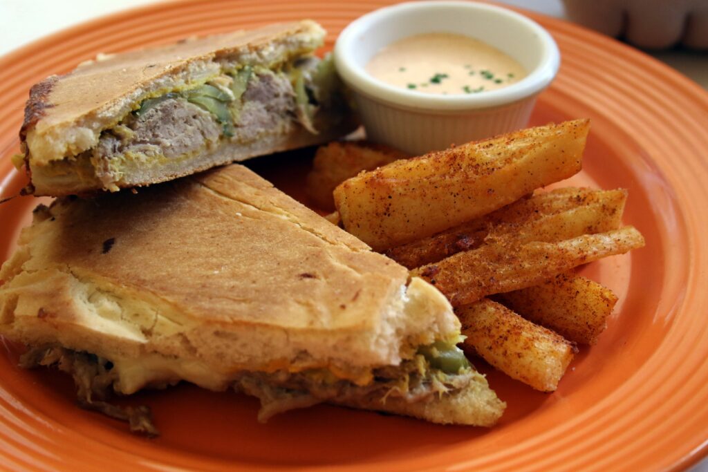 Cubanito sandwich with pulled pork, Swiss cheese, pickles and mustard, and yucca fries from Guiso Latin Fusion in Healdsburg. (Heather Irwin/Sonoma Magazine)