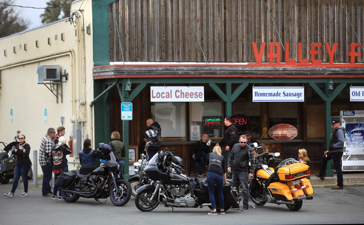 Motorcycle riders from Fairfield take a break at the Valley Ford Market as they head north on Highway 1 through Bodega Bay, Saturday, May 2, 2020. (Kent Porter / The Press Democrat) 