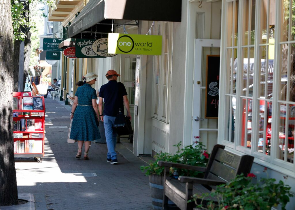 (FILE PHOTO) A couple window shops outside stores in a building along Matheson Street that had been eyed for a potential hotel in Healdsburg. (Alvin Jornada / The Press Democrat)