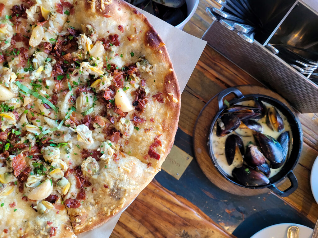 Smoked clam flatbread and mussels at Gourmet Au Bay in Bodega Bay. (Heather Irwin / Sonoma Magazine)