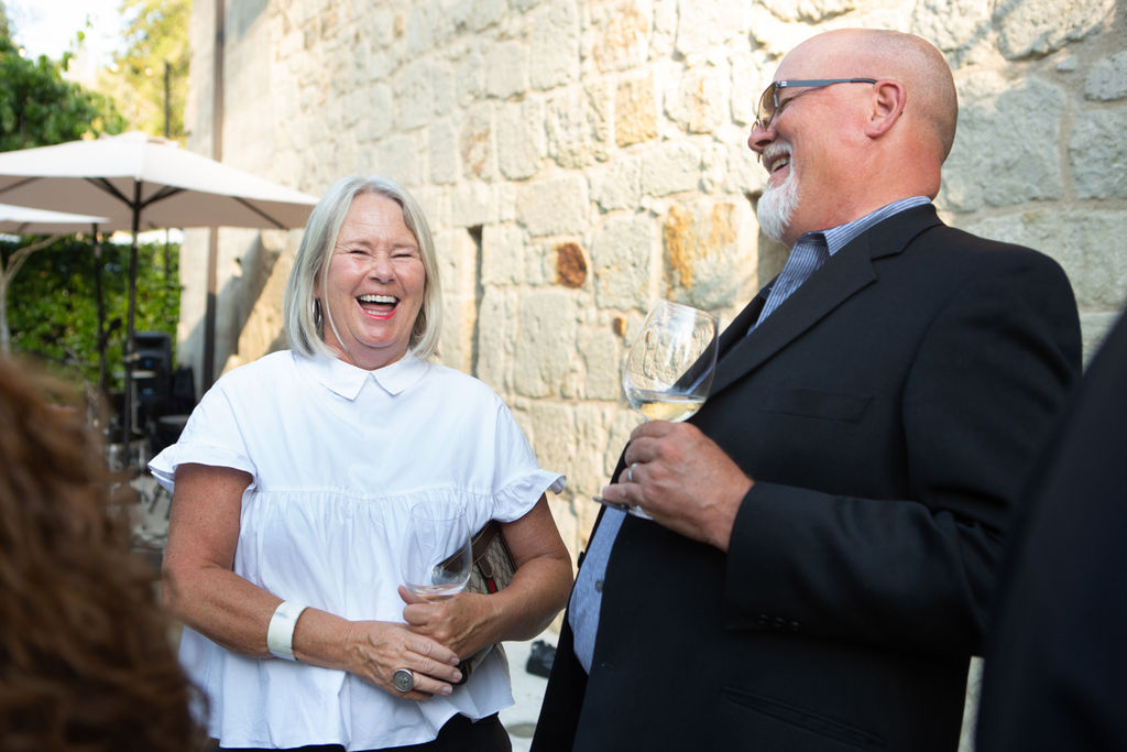Lene Jannes, left and Mike Johnson share a laugh at the Sonoma Magazine 10th Anniversary Party at Buena Vista Winery in Sonoma, CA. The event took place on July 28, 2022. (Photo by Charlie Gesell)