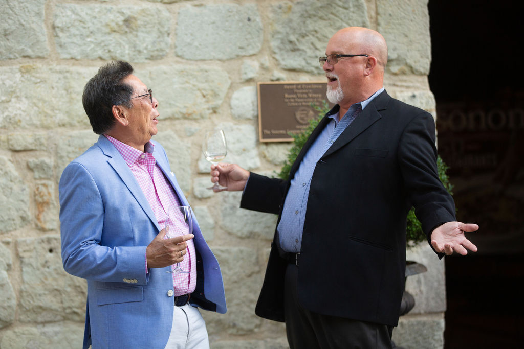 Frank Chong, left, talks with Mike Johnson of Novato at the Sonoma Magazine 10th Anniversary Party at Buena Vista Winery in Sonoma, CA. The event took place on July 28, 2022. (Photo by Charlie Gesell)