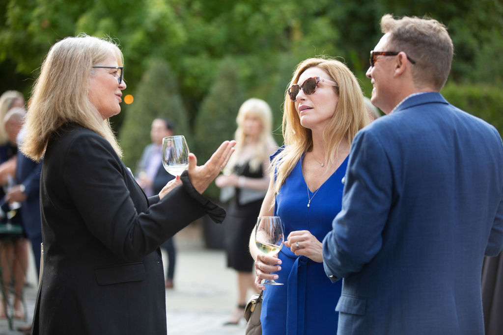 SMI's Karleen Arnink-Pate, left, speaks with Alexandra O'Gorman and Christopher O'Gorman at the Sonoma Magazine 10th Anniversary Party at Buena Vista Winery in Sonoma, CA. The event took place on July 28, 2022. (Photo by Charlie Gesell)
