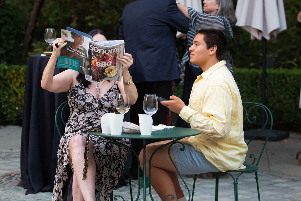 Diane DuBois peruses a copy of Sonoma Magazine as her son Lorenzo Morales-DuBois looks on at the Sonoma Magazine 10th Anniversary Party at Buena Vista Winery in Sonoma, CA. The event took place on July 28, 2022. (Photo by Charlie Gesell)