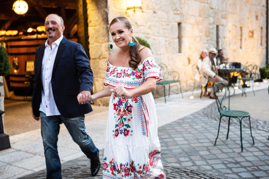 Anthony Quattrocchi, left, and his wife Alicia head out to the dance floor at the Sonoma Magazine 10th Anniversary Party at Buena Vista Winery in Sonoma, CA. The event took place on July 28, 2022. (Photo by Charlie Gesell)