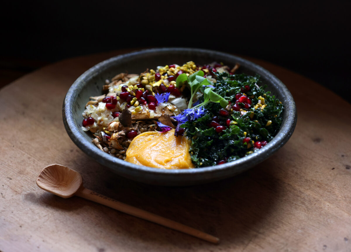 A bowl of try-colored quinoa topped with French green lentils, leeks, shallots, roasted mushrooms, kale salad with saffron vinaigrette, pistachios, pomegranate, and butternut squash puree with coconut cream at The Branch Line in Santa Rosa. (Beth Schlanker/The Press Democrat)