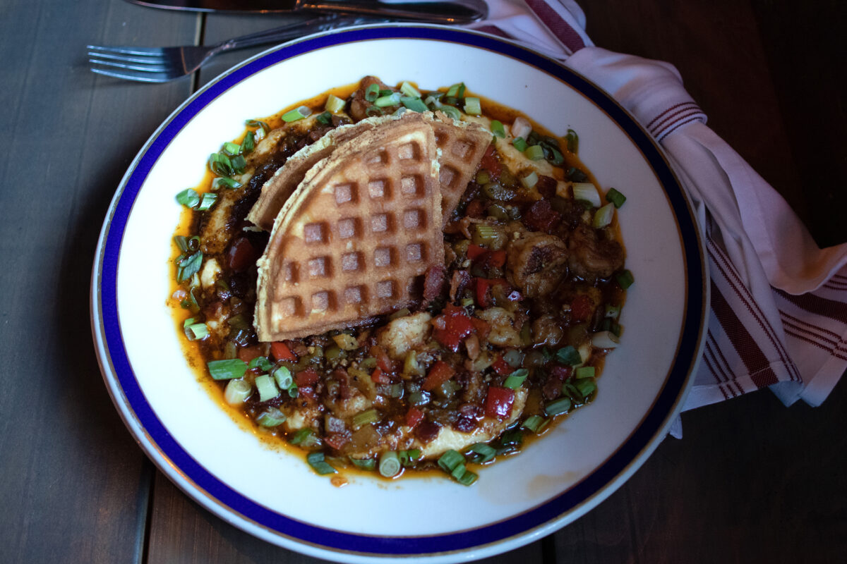 The shrimp and grits special with waffles on top from Saucy Mama’s Jook Joint in Guerneville. (Heather Irwin / The Press Democrat)