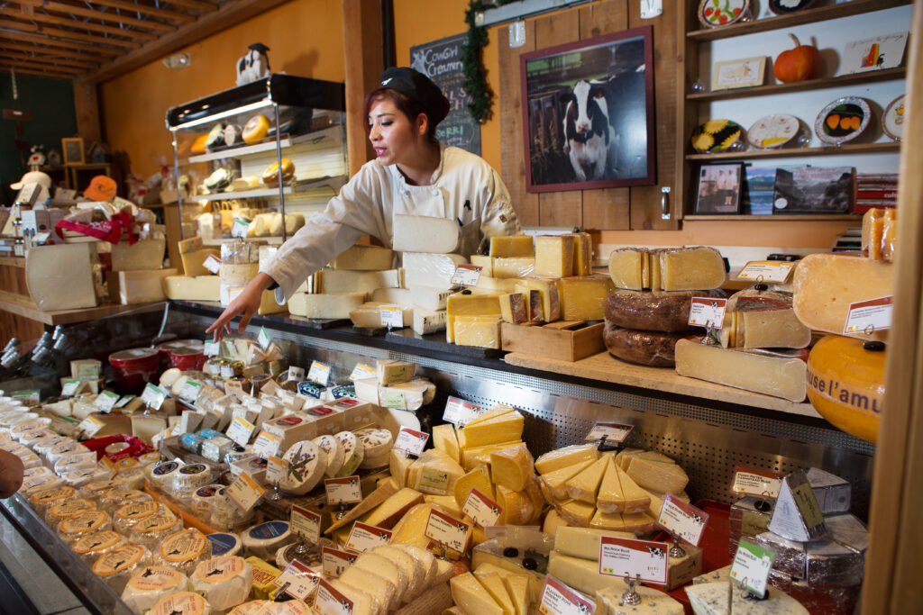 Cowgirl Creamery employee Erica Martinez helps a customer at company's Point Reyes Station location in 2013. The retail shop and one-time factory will permanently close on Sept. 5. (Charlie Gesell )