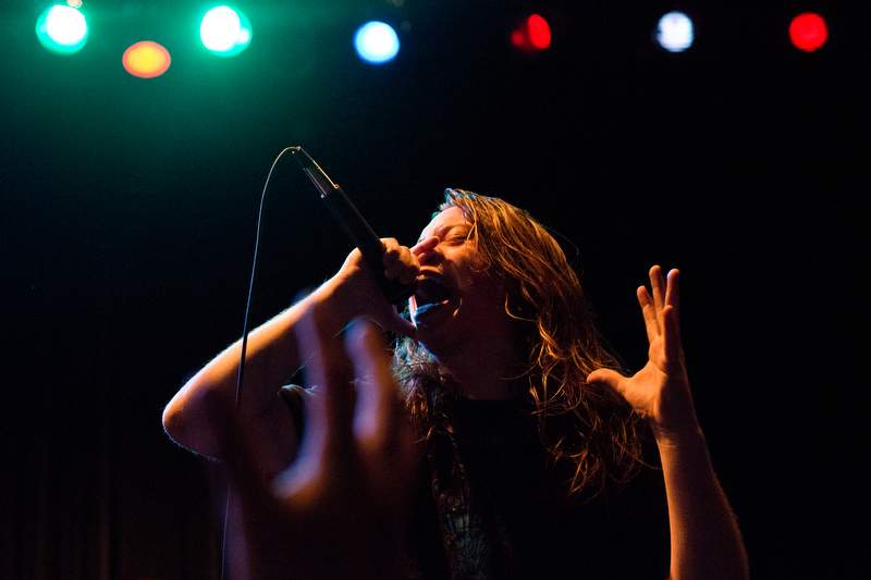 A fan reaches up to A Sun That Never Sets lead singer Mike McCubbin during a heavy metal concert at The Phoenix Theater in Petaluma, Calif., on April 19, 2013. (Alvin Jornada / The Press Democrat)