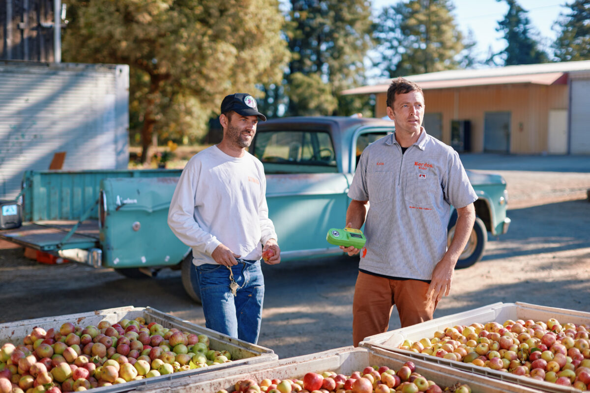 Aaron Brown, in white shirt, and Colin Blackshear at Ratzlaff Ranch, where they press their fruit. (Kim Carroll)