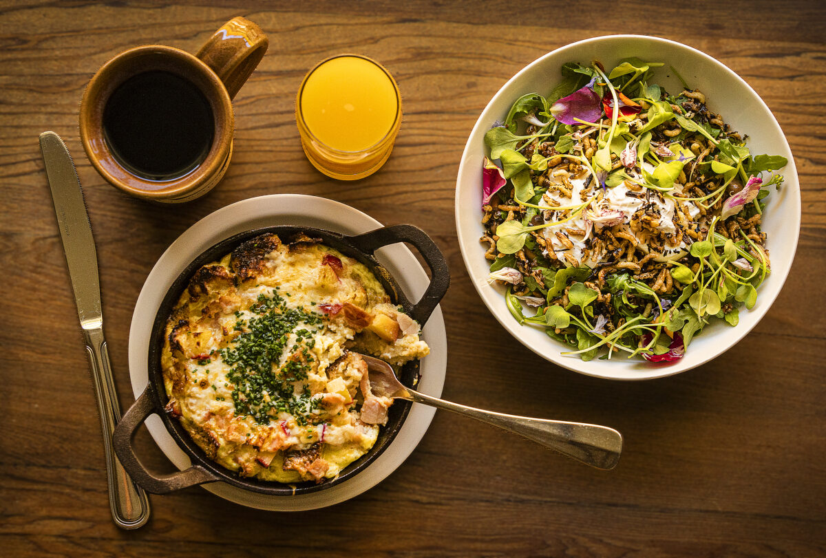 Breakfast choices include a seasonal Peach and Ham Strata with olives, left, and the Savory Breakfast Bowl with quinoa, arugula, pickled mushrooms, avocado, poached eggs and puffed rice from The Farmstand at the Farmhouse Inn in Forestville Tuesday, August 16, 2022. (John Burgess/The Press Democrat)