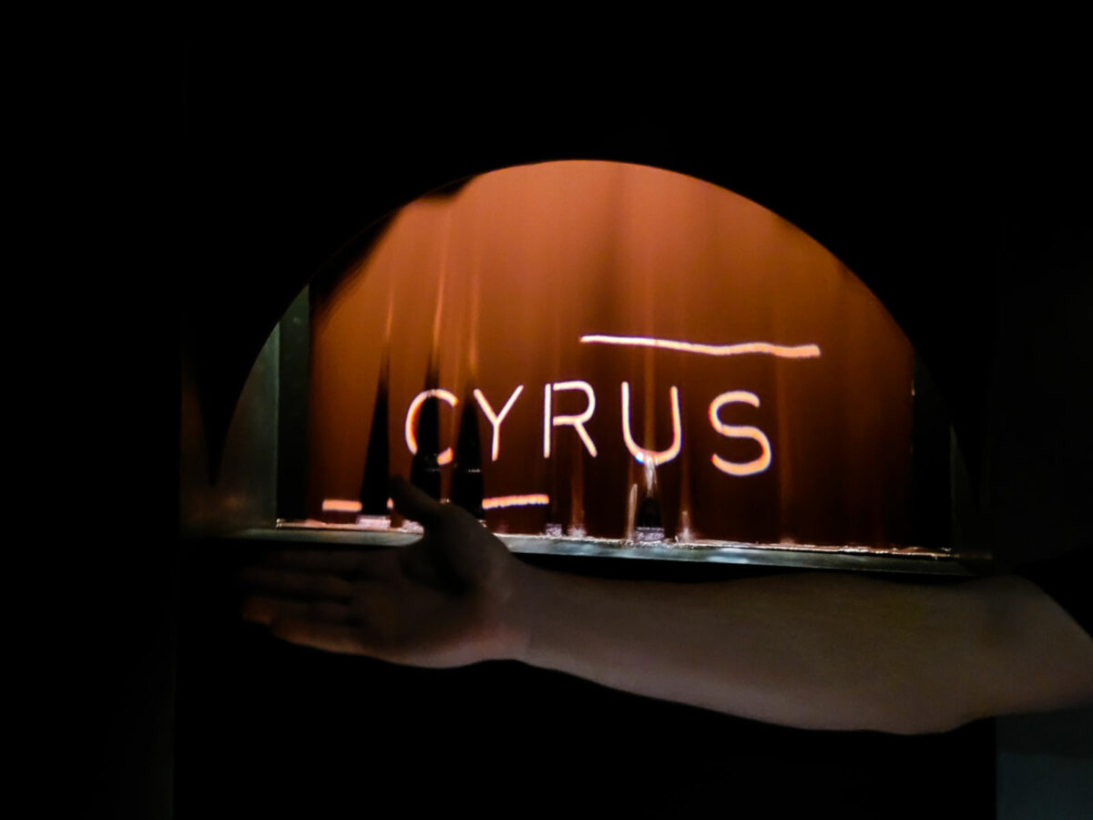 A curtain of melted chocolate lighted by the Cyrus logo at Cyrus restaurant in Geyserville. (Heather Irwin / Sonoma Magazine)