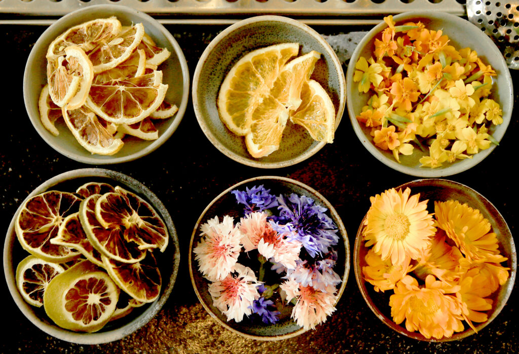 Dried fruits and flowers are used to highlight mixed drinks at Little Saint in Healdsburg, Wednesday, July 21, 2022. (Kent Porter / The Press Democrat) 2022
