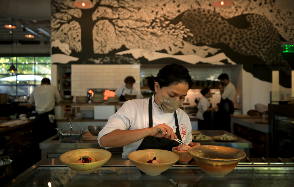 Evening meals are prepared at Little Saint in Healdsburg, Wednesday, July 21, 2022. (Kent Porter / The Press Democrat) 2022