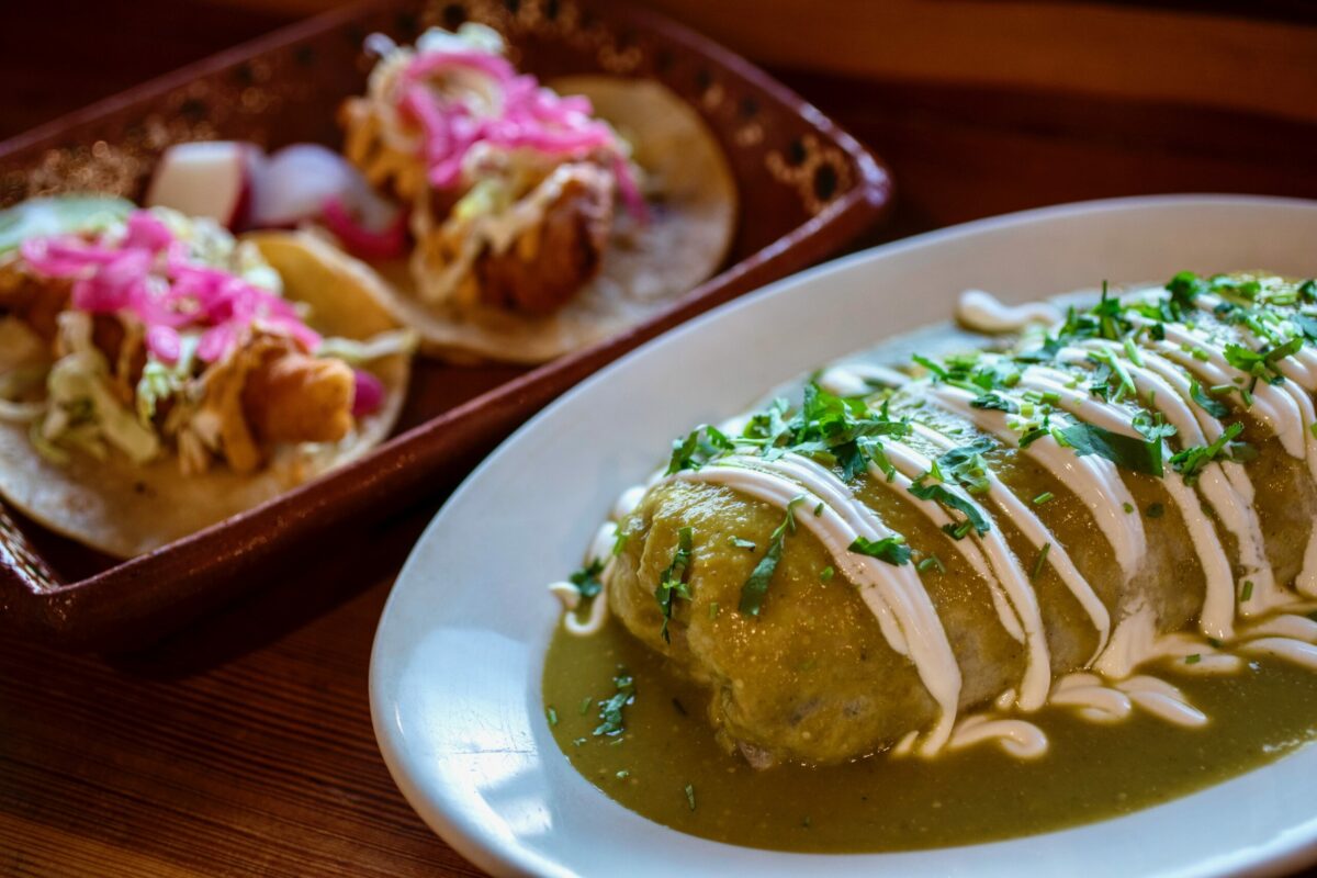 The wet supreme burrito in Suiza salsa, foreground, and Baja fish tacos by Chef Efrain Balmes at Sonoma Eats in Sonoma Tuesday November 22, 2022. (Chad Surmick / Press Democrat)