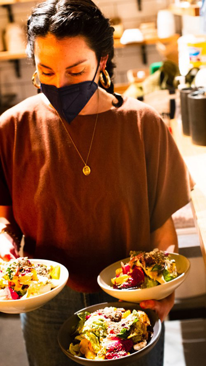 Geneva Melby, who carries bowls of food, and Ryan Miller will open The Redwood, a natural wine bar, in Sebastopol in late 2022. (The Redwood)