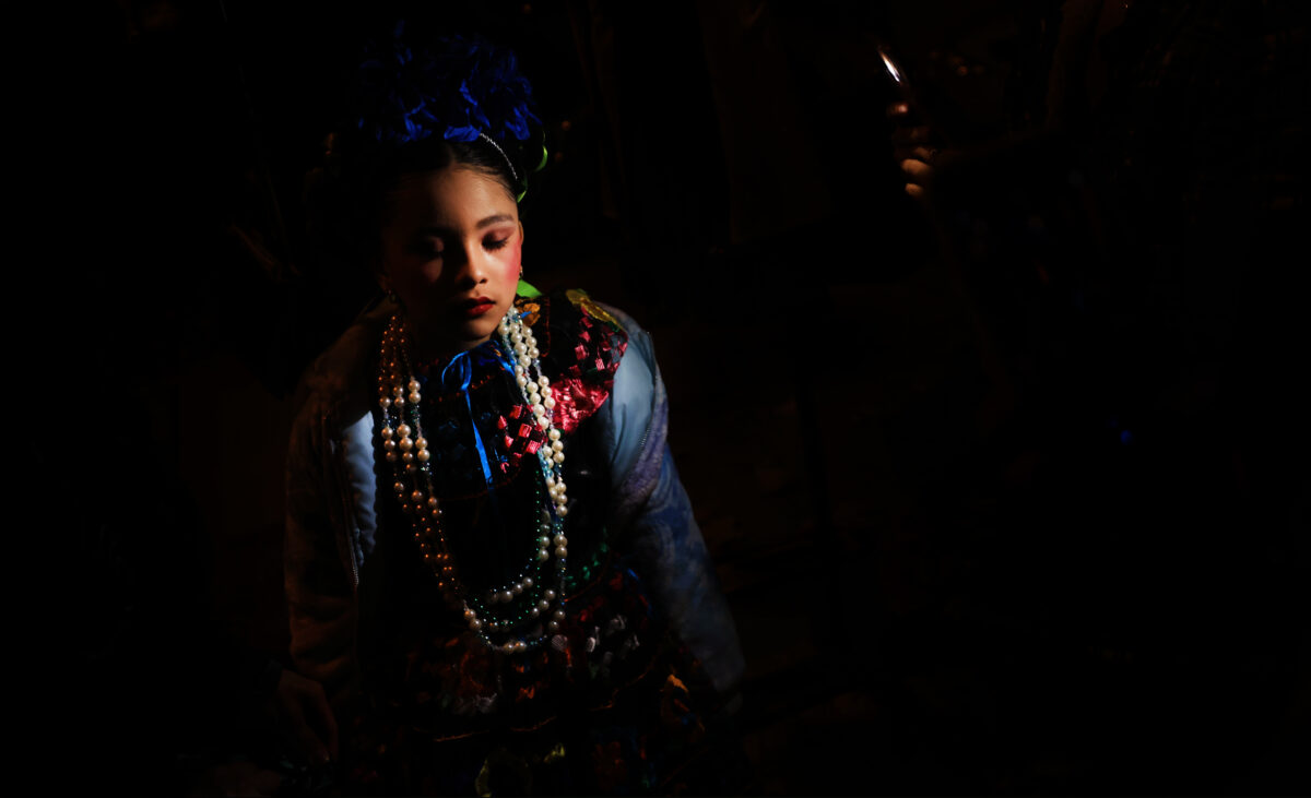 Luna Renovato, 7, of Ballet Folklorico Jazmin of Santa Rosa pauses before performing during Windsor's Día de los Muertos, Saturday, Oct. 30, 2021. (Kent Porter / The Press Democrat) 