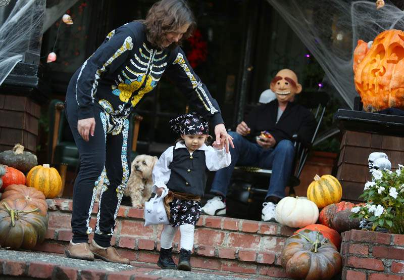 Isabella Chandler, 2, trick-or-treats during Halloween along McDonald Avenue in Santa Rosa on Thursday, October 31, 2013. (Conner Jay/The Press Democrat)