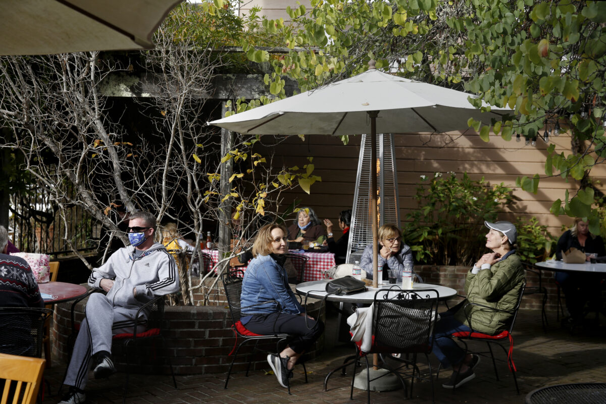 Customers wait for their food in the outdoor seating area at the Union Hotel in Occidental. (Beth Schlanker/The Press Democrat)