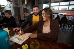 John Fitch and Stacie Rodriguez, both of Santa Rosa, fill out their answers to trivia questions during trivia night presented by North Bay Trivia at Golden State Cider Taproom, Thursday, October 13, 2022, in Sebastopol. (Darryl Bush / For The Press Democrat)