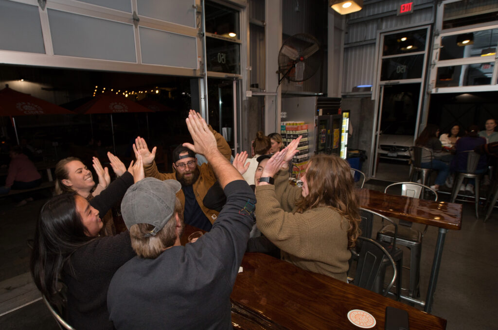 The six-person winning team, calling themselves the "Bidets and Confused," celebrate their first place win at the end of trivia night presented by North Bay Trivia at Golden State Cider Taproom, Thursday, October 13, 2022, in Sebastopol. (Darryl Bush / For The Press Democrat)