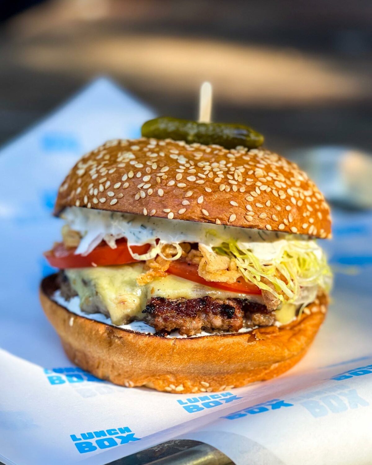 House-ground patty with Sonoma County Meat Co. bacon and brisket and chuck, chèvre ranch, Joe Matos cheese, crispy shallots, tomato, and shredded iceberg on Costeaux French Bakery brioche. (Courtesy of Lunch Box)