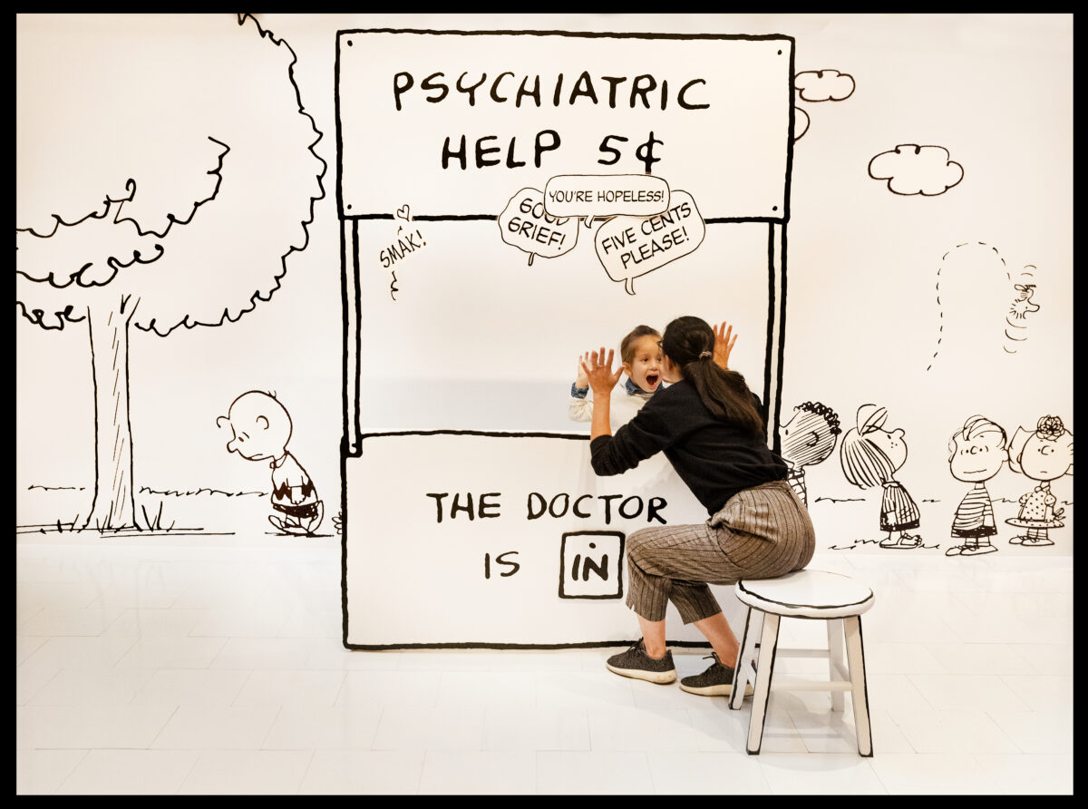 Jen Hyde and her son, Reyner Delorey, 3, play in the Lucy's Psychiatric Booth interactive exhibit at the Charles M, Schulz Museum in Santa Rosa. (John Burgess/The Press Democrat)