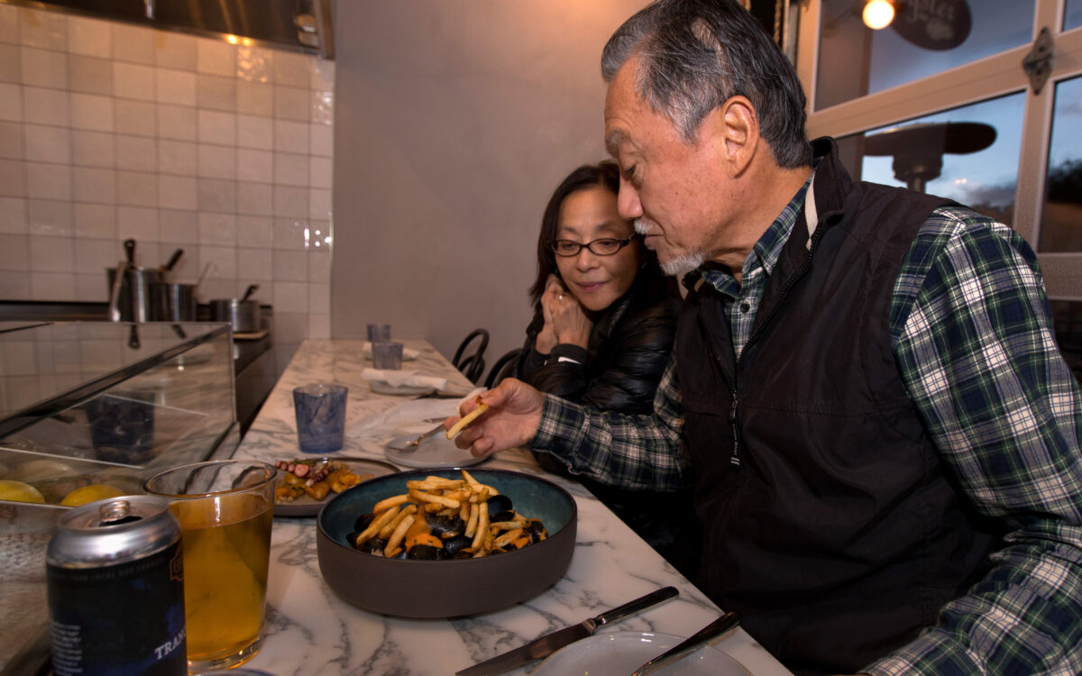 Takashi Sugiyama, right, and Yuko Sugiyama, both of Sunnyvale, begin their meal at Oyster, a new restaurant in The Barlow, Monday, November 7, 2022, in Sebastopol. (Darryl Bush / For The Press Democrat)