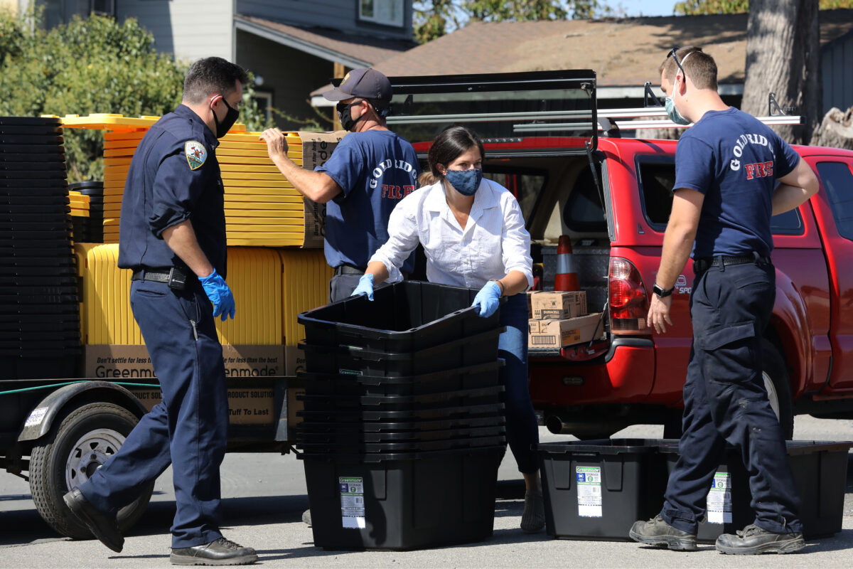 Jacqui Jorgeson, founder of the Volunteer Fire Foundation, gets help from firefighters and volunteers creating boxes for volunteer firefighters in Sonoma County at the Gold Ridge Fire Protection District's Hessel station in Sebastopol. (Beth Schlanker/The Press Democrat)