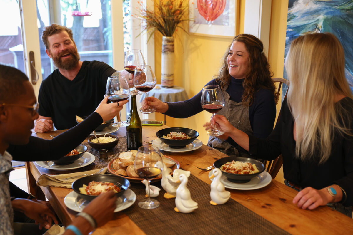 Siblings Eric and Jennifer Reichardt toast before a dinner with friends in Petaluma. (Christopher Chung/The Press Democrat)