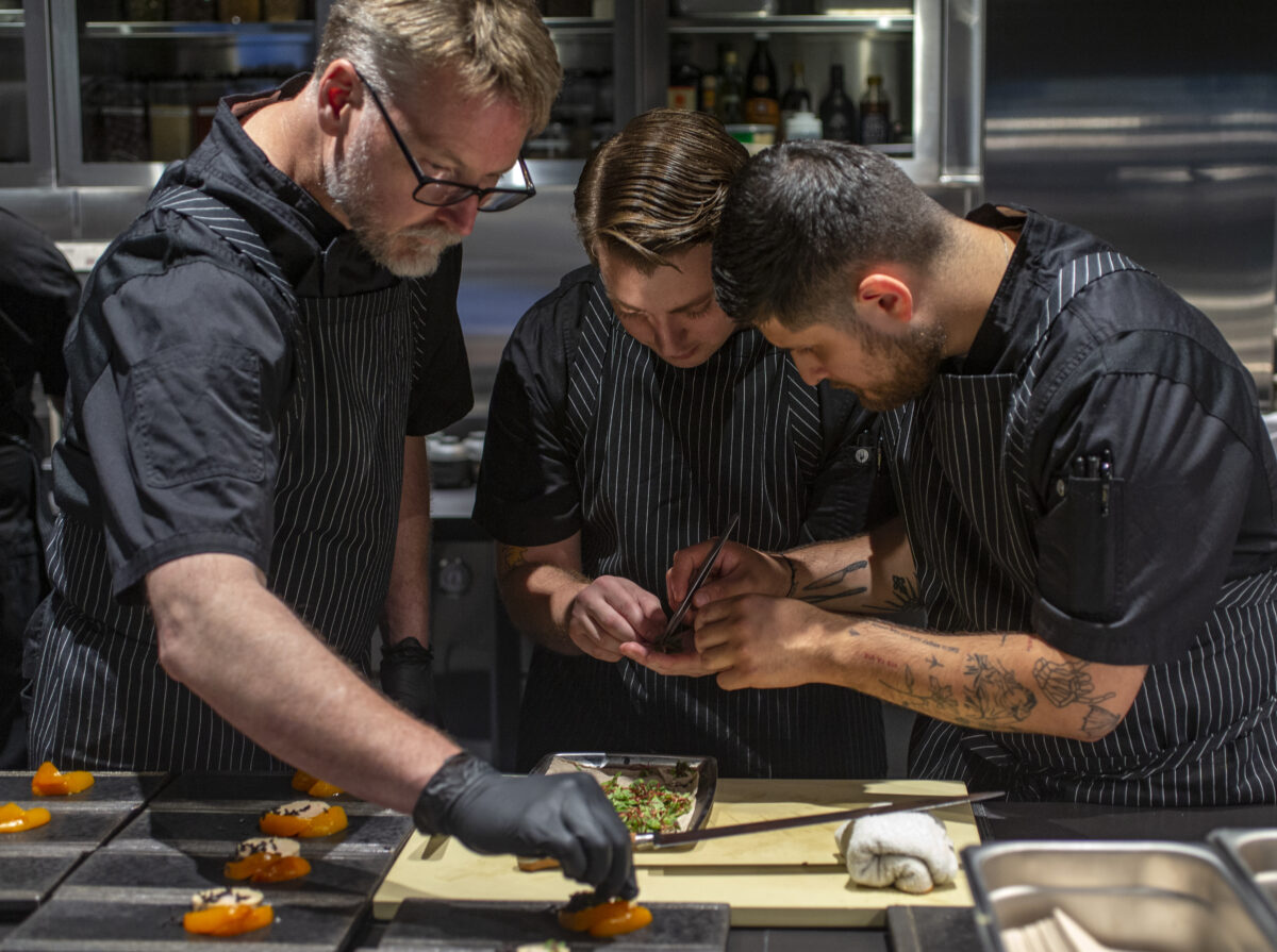 Chef Drew Glassell, left, assembles Foie Gras Torchon in the kitchen at Cyrus in Geyserville. (Chad Surmick/The Press Democrat)