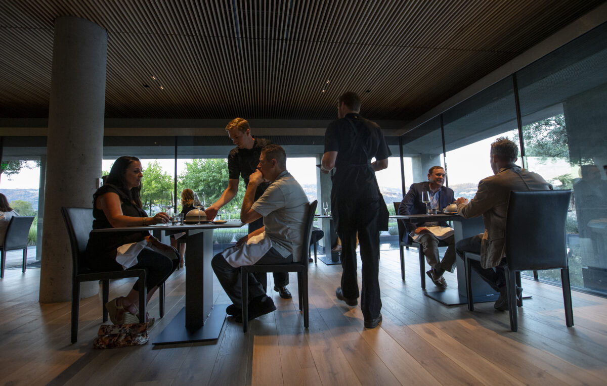 During a family and friends pre-opening night guests enjoy the dining room with sweeping views at sunset of the Alexander Valley at Cyrus in Geyserville on Thursday September 8, 2022. (Chad Surmick / Press Democrat)