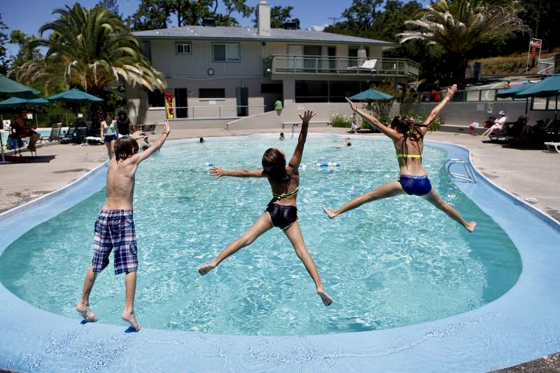(From left) Siblings, Carter Gardea, 9, Sophia, 7, and Camille, 12, jump into the pool at Morton's Warm Springs in Glen Ellen, California on Thursday, June 30, 2011. (BETH SCHLANKER/ The Press Democrat)