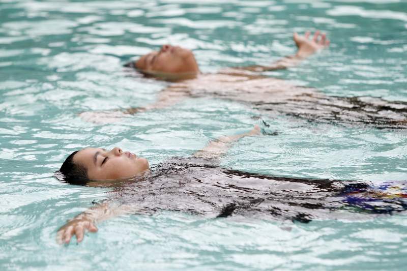 Eduardo Varges, 11, left, and his cousin Cristian Cazarez, 10, float in the pool at Morton's Warm Springs in Glen Ellen, California on Wednesday, June 29, 2011. (BETH SCHLANKER/ The Press Democrat)