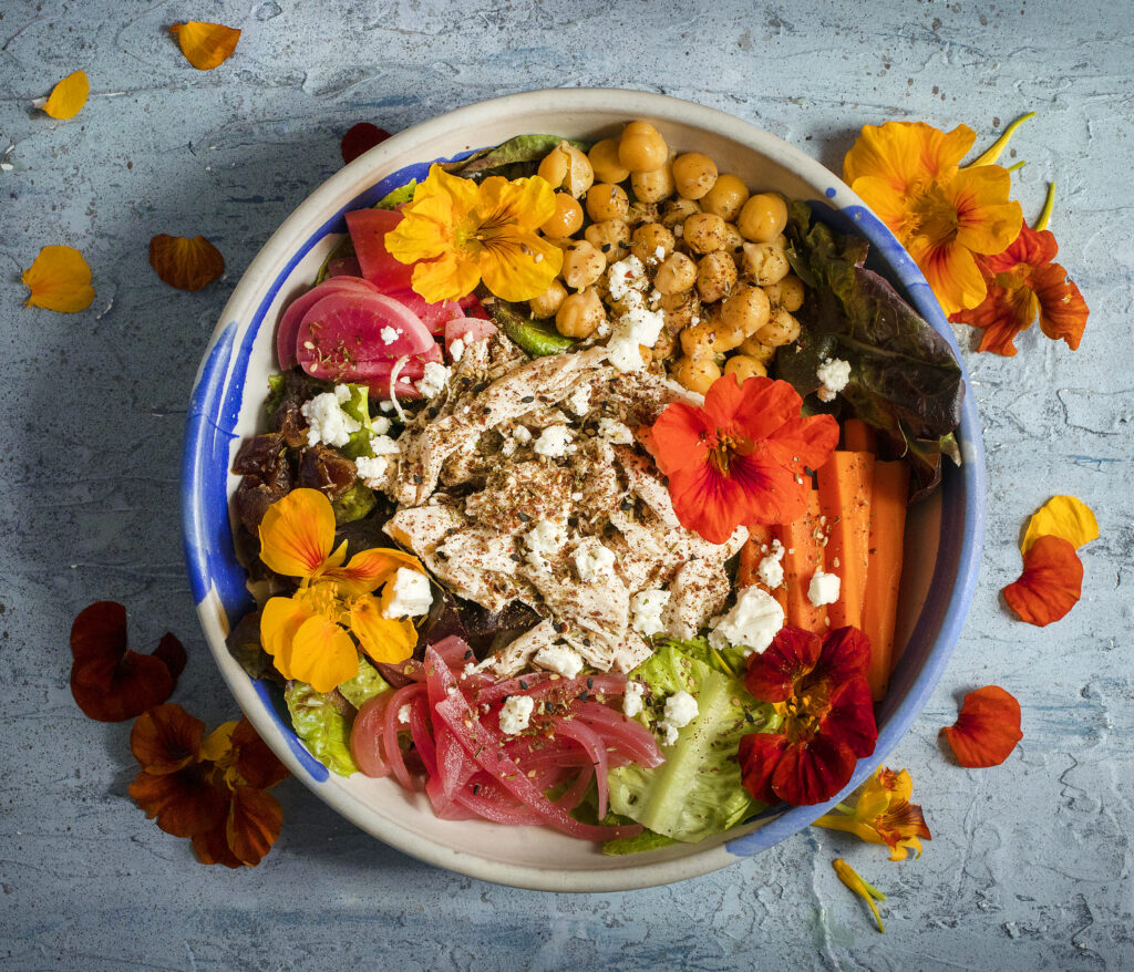 Chicken + Za'atar Salad with greens, chicken, garbanzos, pickles (radish, carrots + red onions), dates, feta and a banyuls vinaigrette from the Miracle Plum Kitchen in Santa Rosa. (John Burgess/The Press Democrat)