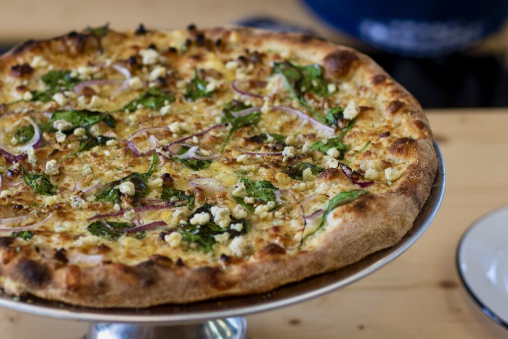Blue cheese meets mozzarella, oregano and basil on a specialty pizza at Acre Pizza in Sebastopol. (Heather Irwin / The Press Democrat)